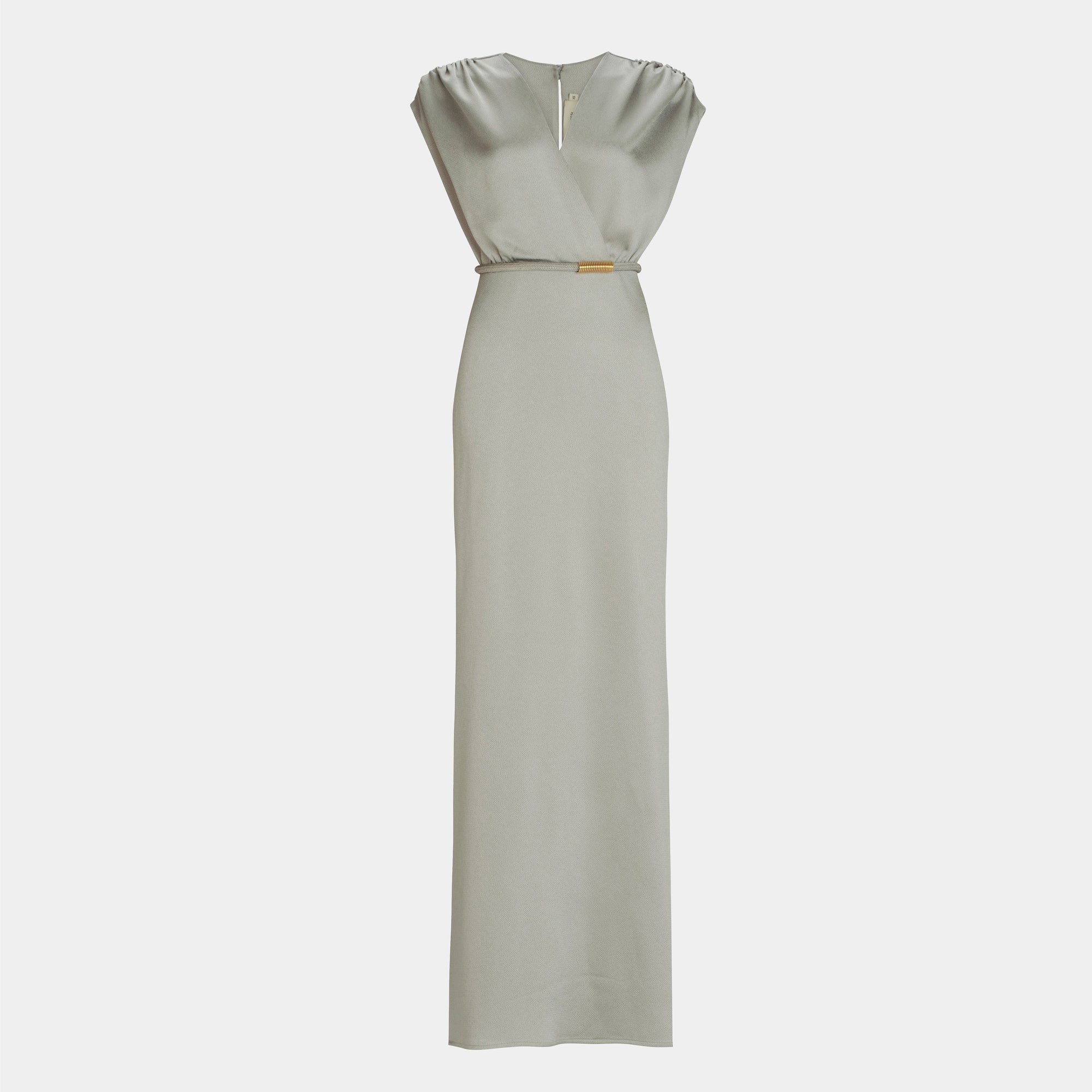 The Freda Dress by SVT DESIGNS is a light gray, floor-length maxi with a V-neckline, sleeveless design, subtle shoulder gathers, a fitted silhouette, and a small metallic accent at the waist.