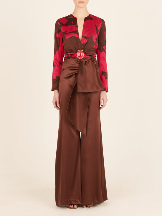 A pink and brown Edith Blouse Fuchsia Cacao with a belt, featuring an Italian resin detail.