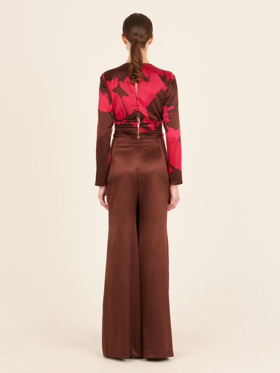 A pink and brown Edith Blouse Fuchsia Cacao with a belt, featuring an Italian resin detail.