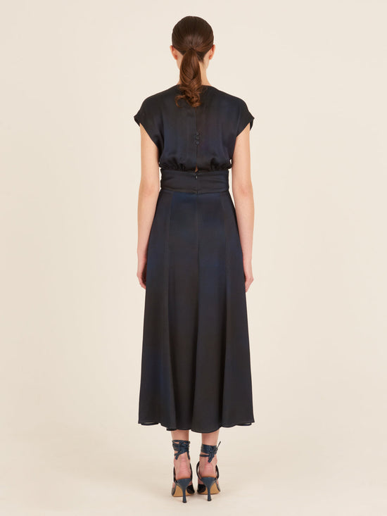 An elegant Emmeline Dress Navy with a buckle on the front.