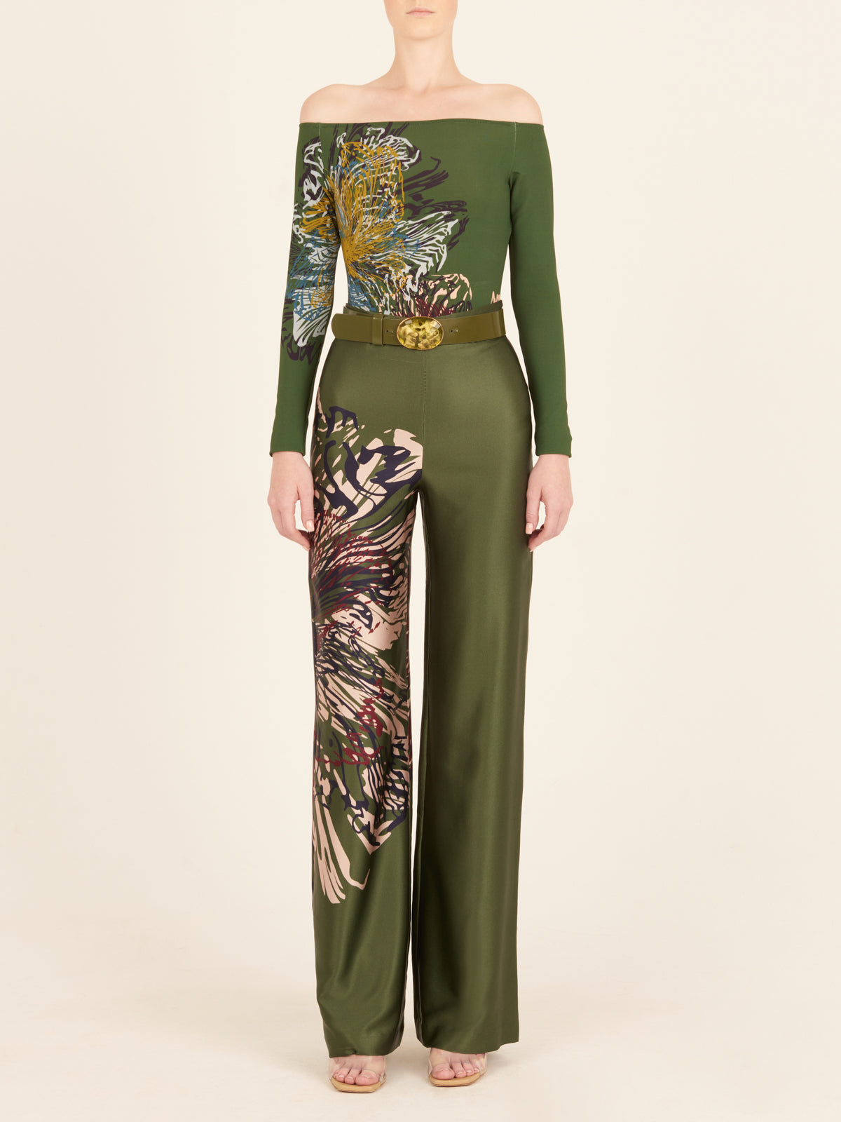 The woman is wearing comfortable green wide leg pants with floral print.
Product Name: Florence Bodysuit Green Floral