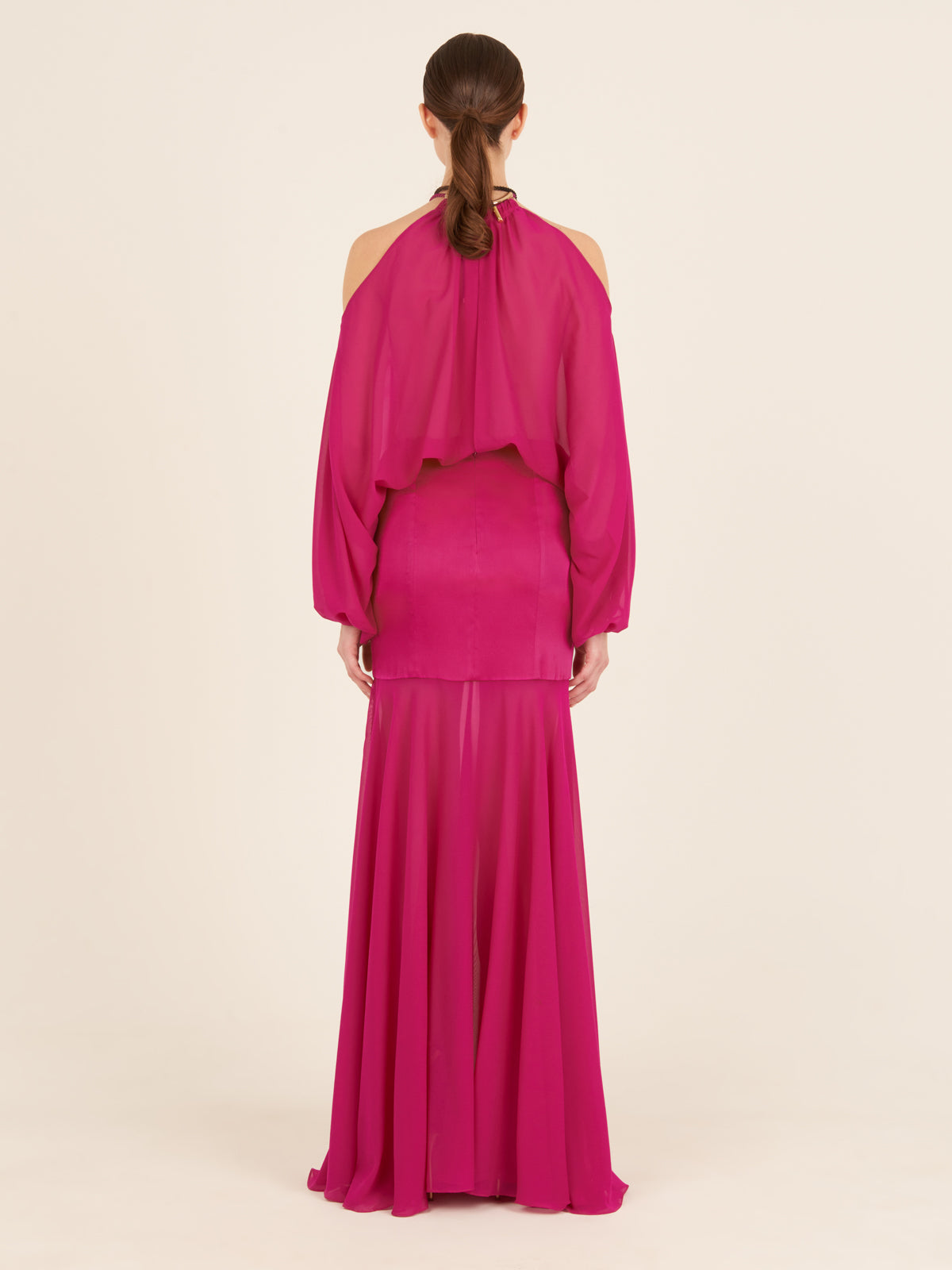 Isadora Dress Fuchsia with sheer long sleeves and a high neck, displayed on a white background.