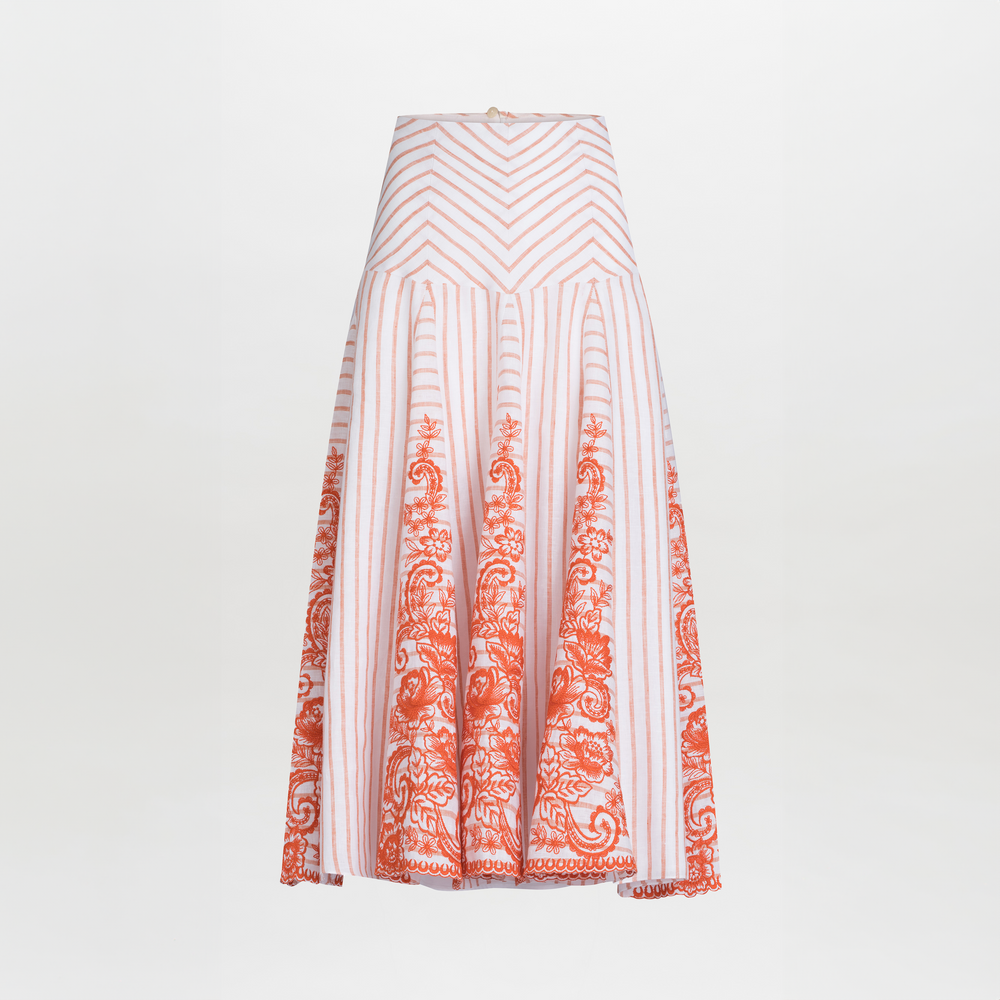 The Fairus Skirt by SVT DESIGNS is a high-waisted A-line midi skirt with vertical pink stripes and orange embroidered linen floral details near the hem, shown on a plain white background.