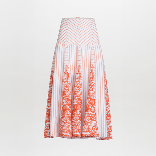 The Fairus Skirt by SVT DESIGNS is a high-waisted midi with pleats, featuring vertical red stripes converging in a chevron pattern. It has ornate floral patterns at the bottom and an invisible zipper on a plain background for an elegant finish.