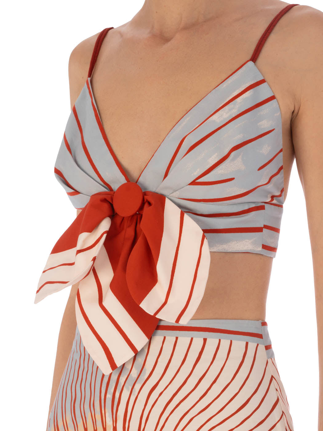 A striped red and white Flor Top Sausalito Sunset bow-style bikini top isolated on a white background.