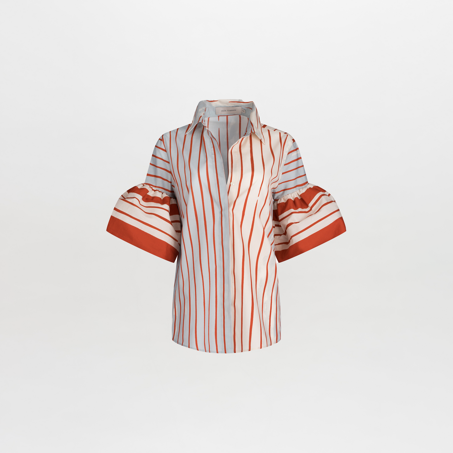 The Helina Blouse by SVT DESIGNS is a white and red striped cotton top with a classic shirt collar and button-down front. It has short, flared sleeves accented with red bands and multicolor vertical stripes of varying widths.