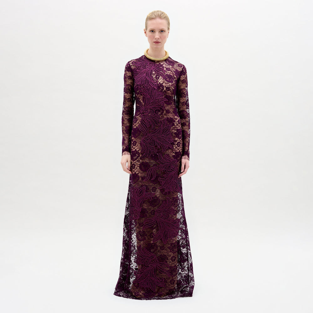 A woman wearing the Ida Dress in color Purple with a golden necklace on a white background.