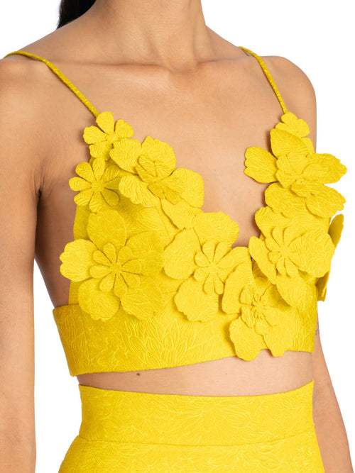 Ibbie Top Limoncello with spaghetti straps and 3D floral detailing, isolated on a white background.