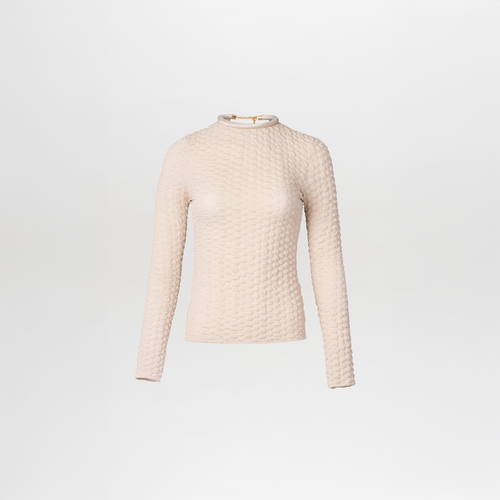 The Jari Top by SVT DESIGNS is a cream-colored, long-sleeve knit sweater with a textured pattern and 3D detailing. It features a high neckline, and its intricate style is displayed on a plain white background.