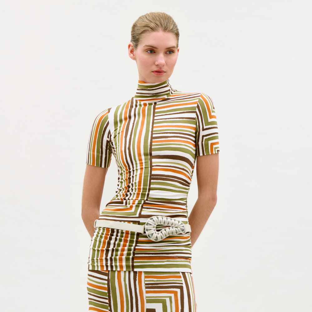 Woman wearing a patterned outfit on a white background