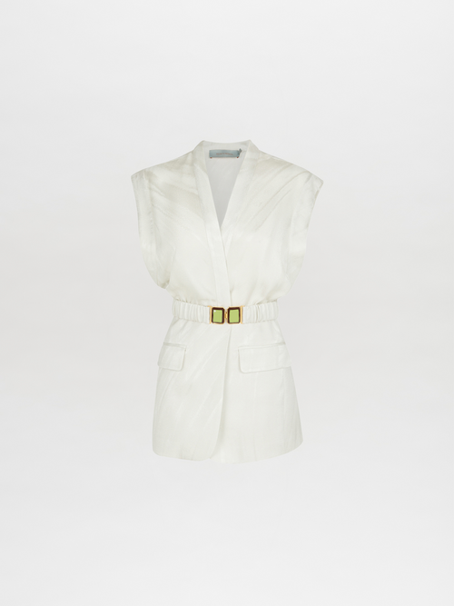 The Silvia Tcherassi Keith Vest Moonstone is a modern, elegant sleeveless white blazer with a deep V-neck, waist-cinching gold buckle belt, and two front flap pockets on moonstone jacquard.