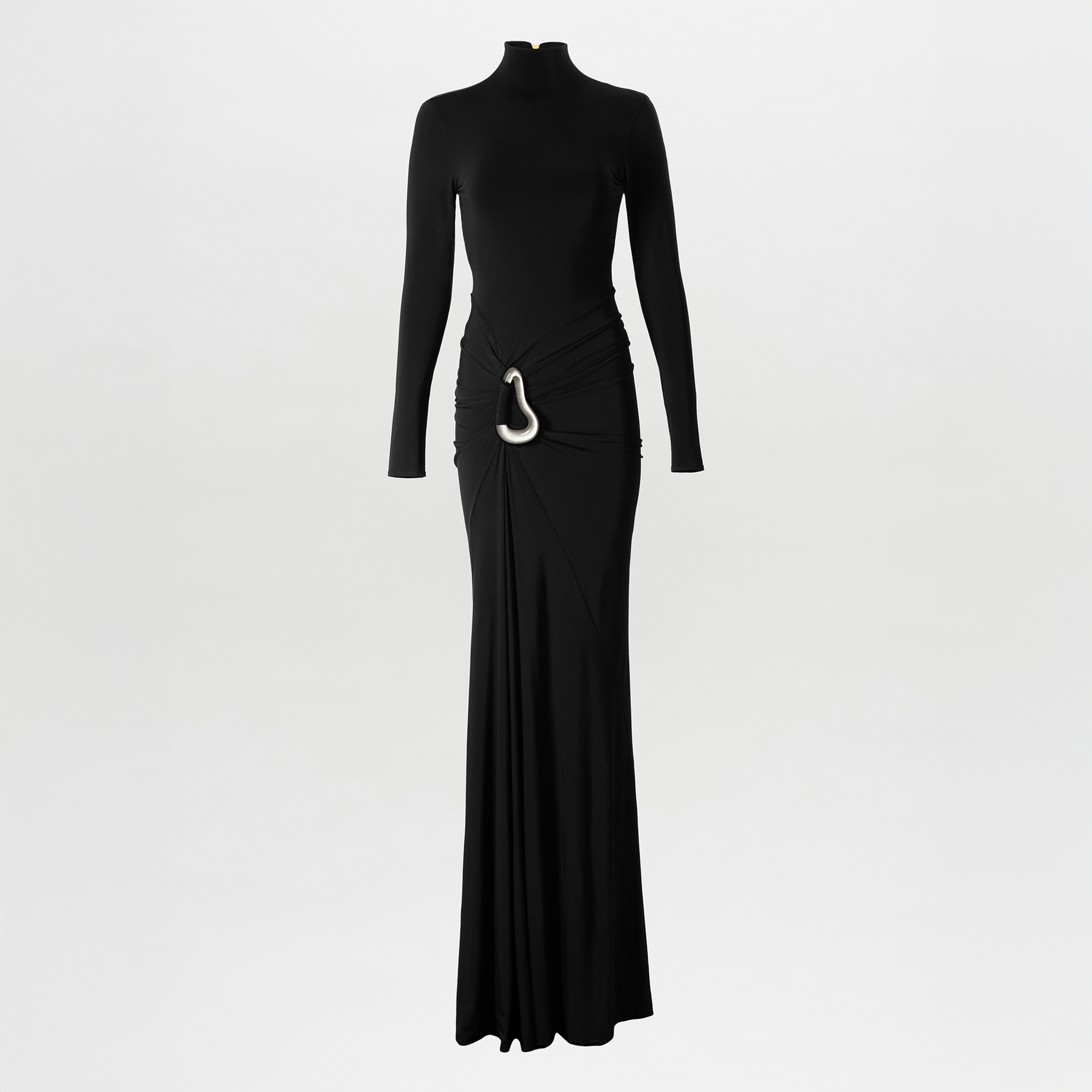 The Lena Dress by SVT DESIGNS is a long black maxi dress with long sleeves, a high neckline, a fitted silhouette, and an asymmetric waistline gathered at the side and finished with a statement metallic buckle.