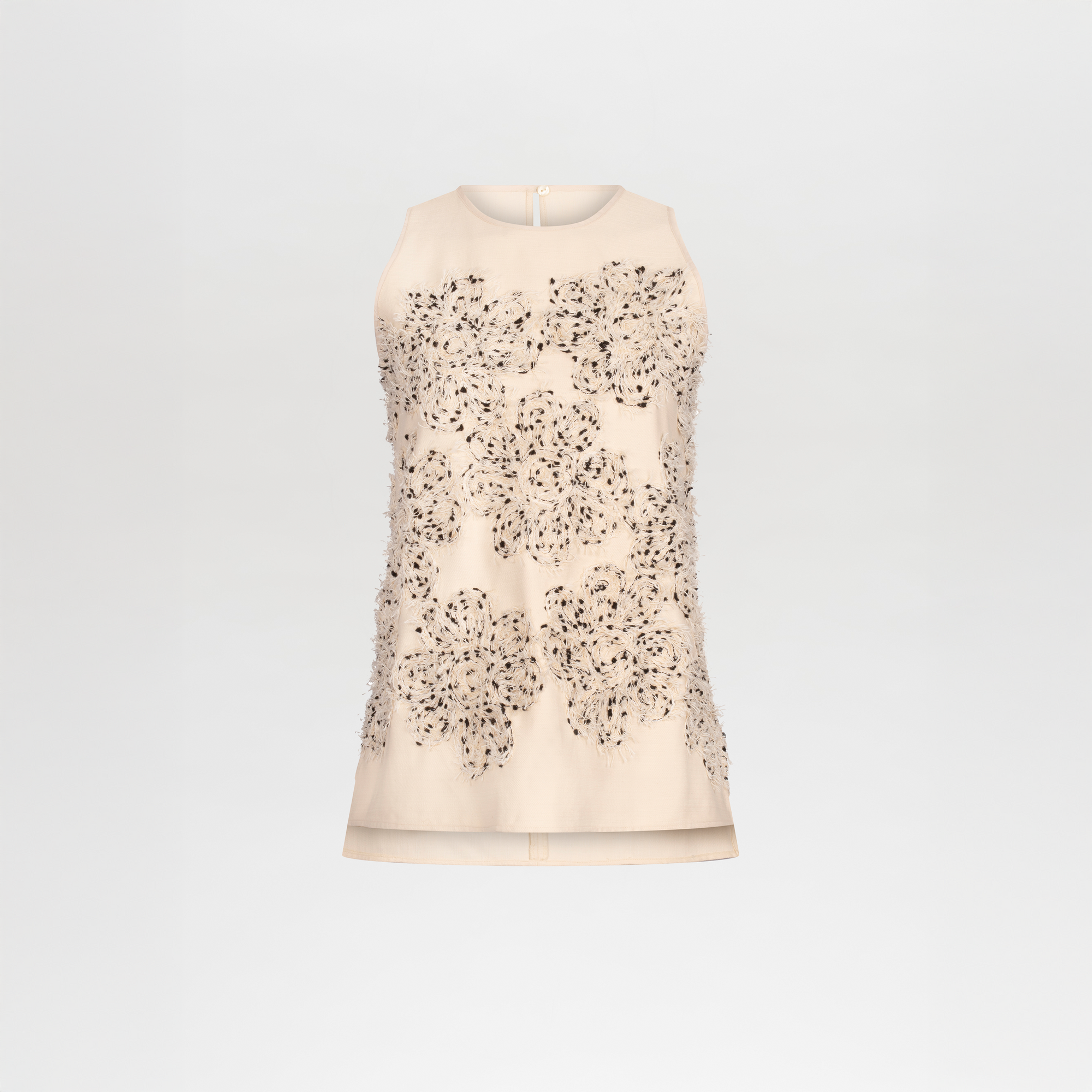 The Leonora Blouse by SVT DESIGNS is a sleeveless, light beige top featuring a round neckline and eye-catching beaded and sequin flower appliqué on the front, crafted from fine Italian textile and shown against a plain white background.