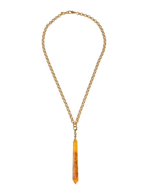 The Montse Necklace Amber is a gold chain necklace featuring a long, narrow pendant in an amber color at the center, perfect for adding a touch of elegance to your look on September 2nd.