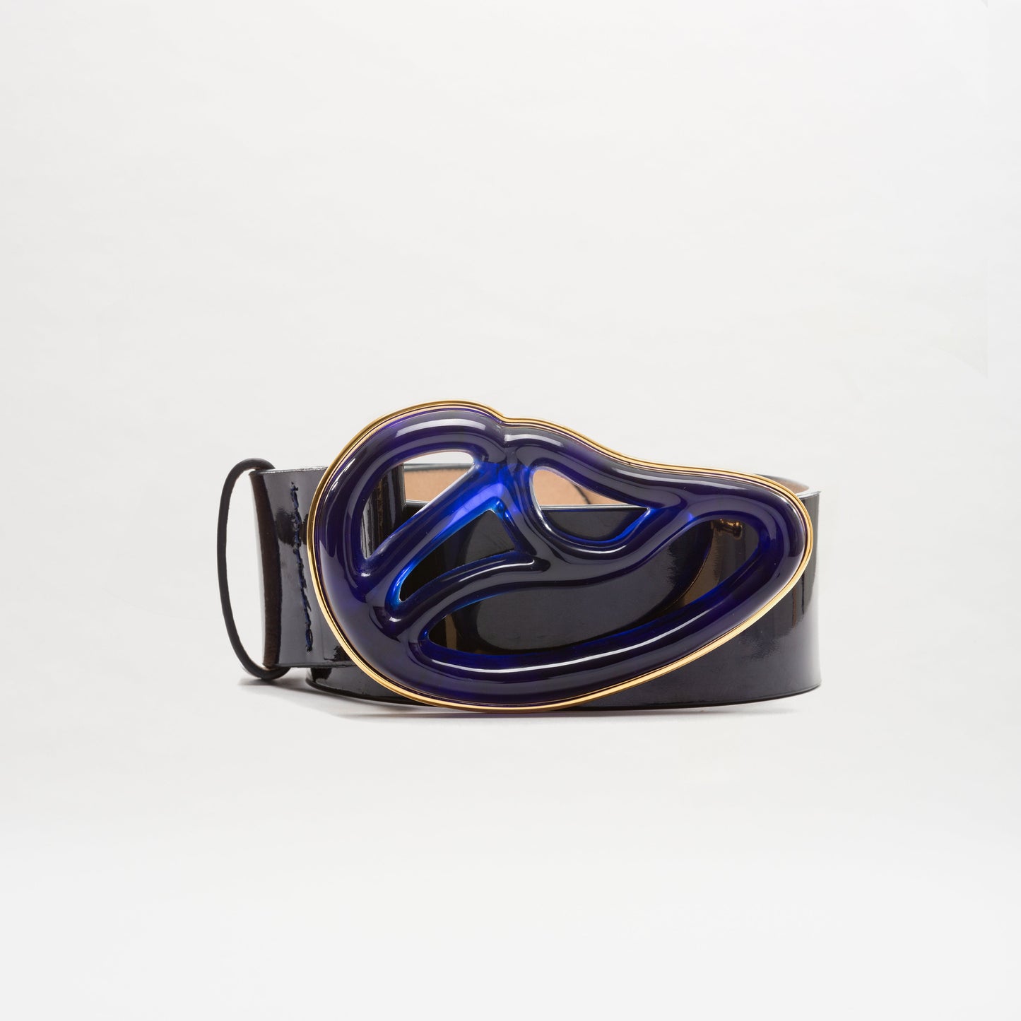 The SVT DESIGNS Nala Belt features black Italian leather and a large, abstract Petralux buckle in metallic blue and gold, pictured on a plain white background.