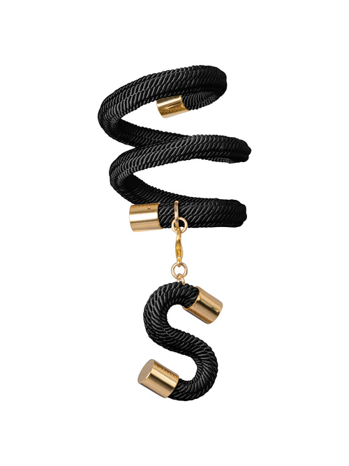 The Nicky Bracelet Black features a coiled black rope ring with gold metal accents and a dangling "S" charm in a matching black and gold design. It's the perfect accessory to add a touch of elegance to your look on any special occasion, like August 19th or September 2nd.