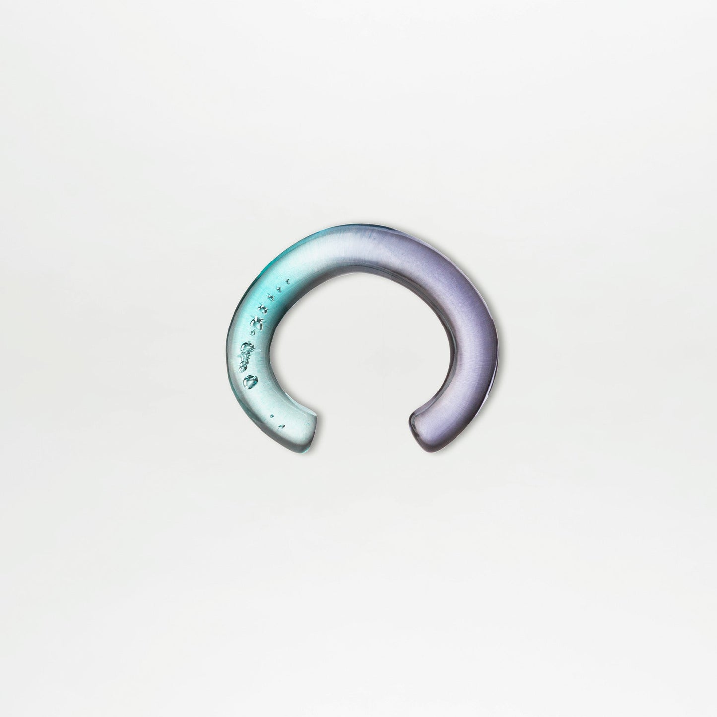The Oli Bracelet by SVT DESIGNS is a crescent-shaped Italian PMMA acrylic piece, featuring a teal-to-purple gradient with sculptural details and subtle decorative marks at the left end, shown on a plain white background.