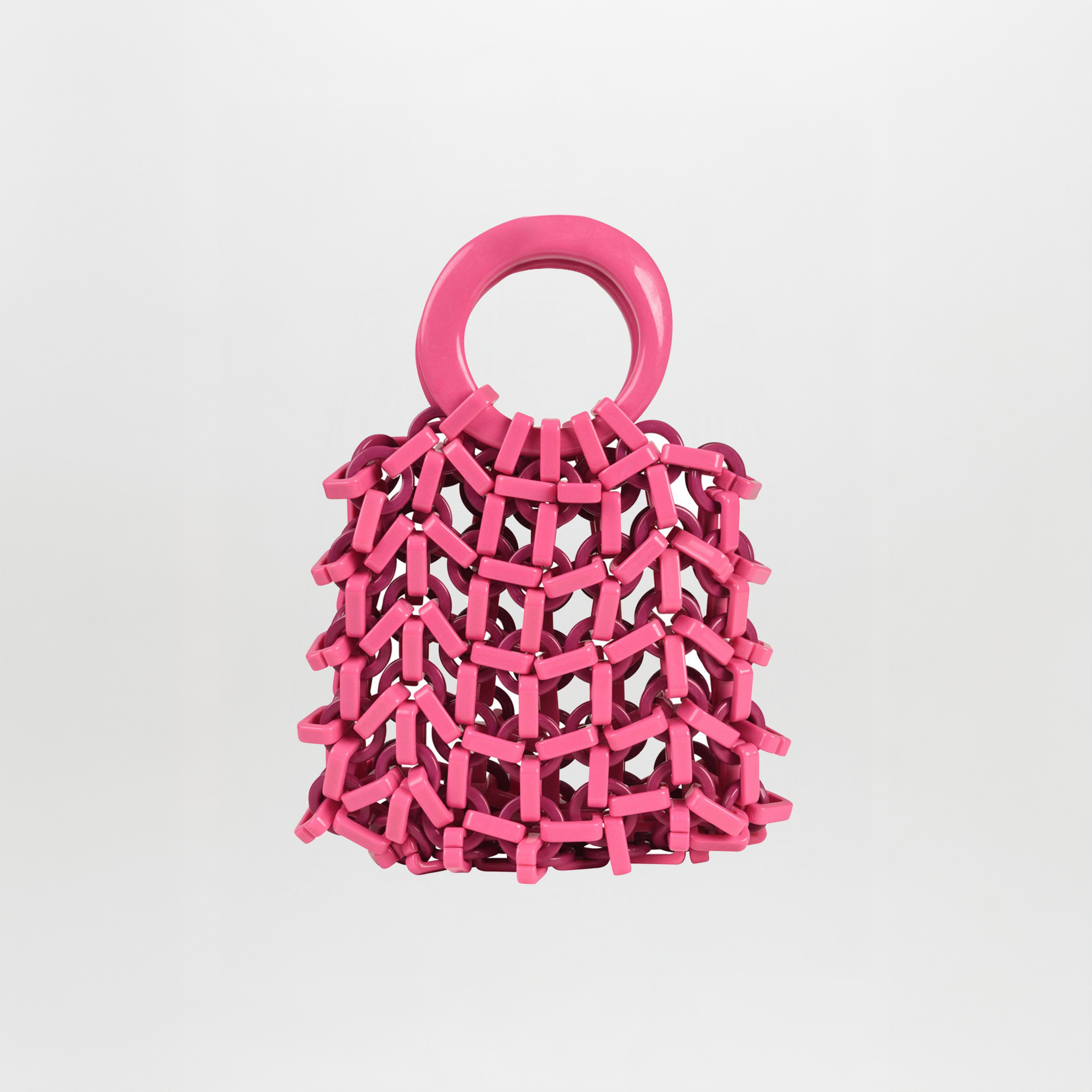 The Omegna Handbag in Magenta/Plum by Silvia Tcherassi features a bold pink acrylic design with a large circular handle and net-like structure, shown against a plain white background.