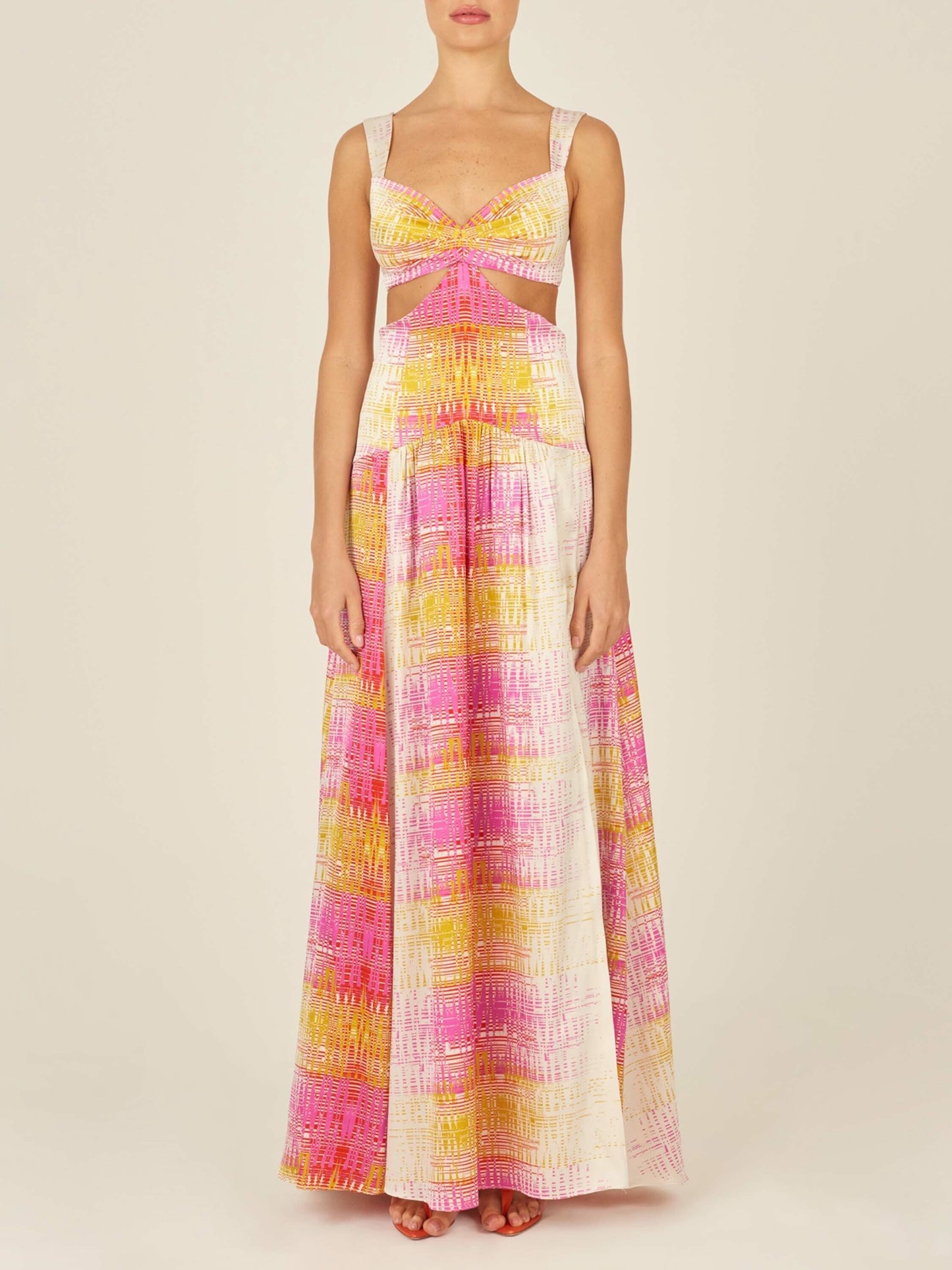 A Cervo Dress White Digital with a colorful, digital electric print in pink, yellow, and white tones, featuring cutout details at the waist and a front knot detail.