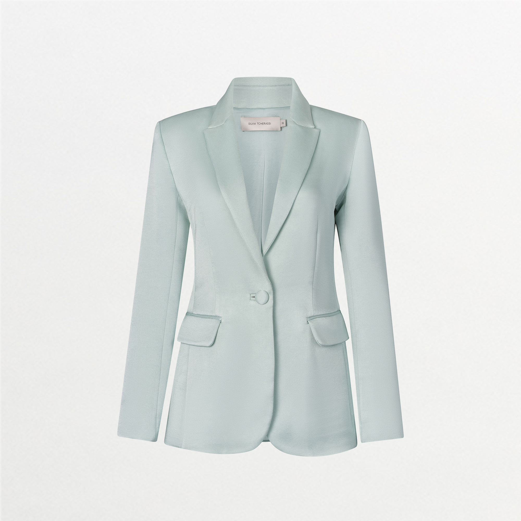 The Rebeca Jacket by SVT DESIGNS is a light blue satin novelty jacket featuring a notch collar, relaxed fit, long sleeves, single button closure, and two front flap pockets, shown against a plain white background.
