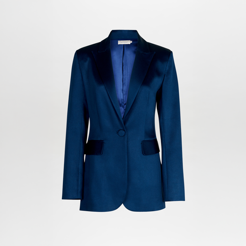 The Rebeca Jacket by SVT DESIGNS is a navy blue, single-breasted blazer with a satin finish and relaxed fit. It features a notched lapel, single button closure, two front flap pockets, and visible interior lining for added sophistication, showcased on a plain white background.