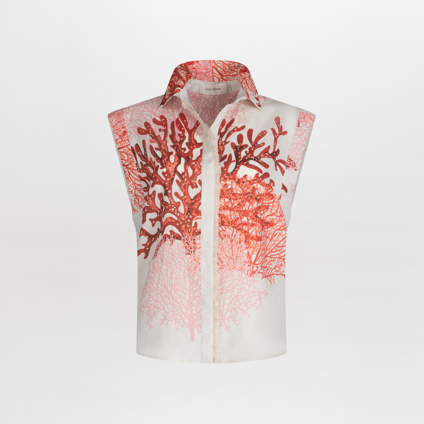 The Rina Blouse by SVT DESIGNS is a sleeveless white linen top with a collar, featuring a red and pink coral motif print on the front over a plain white background.