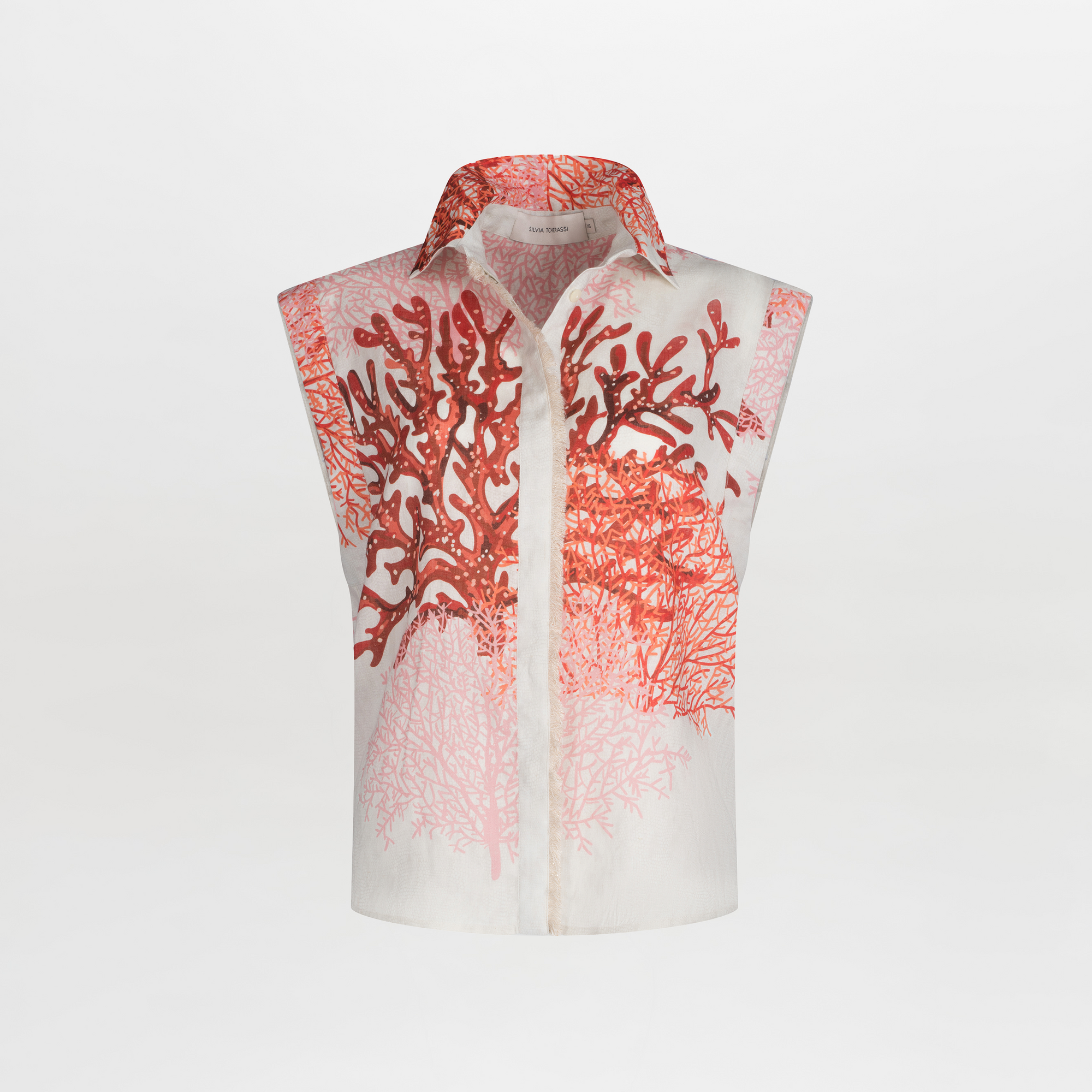 The Rina Blouse by SVT DESIGNS is a sleeveless white linen top with a collar, featuring a red and pink coral motif print on the front over a plain white background.