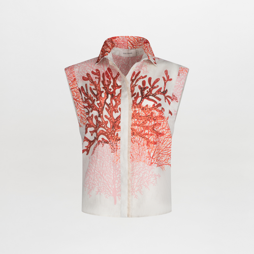 The Rina Blouse by SVT DESIGNS is a sleeveless linen top featuring a vibrant abstract coral motif in multicolor reds and pinks, prominently displayed on the upper and middle sections, offering an elegant seaside charm with its button-up front.