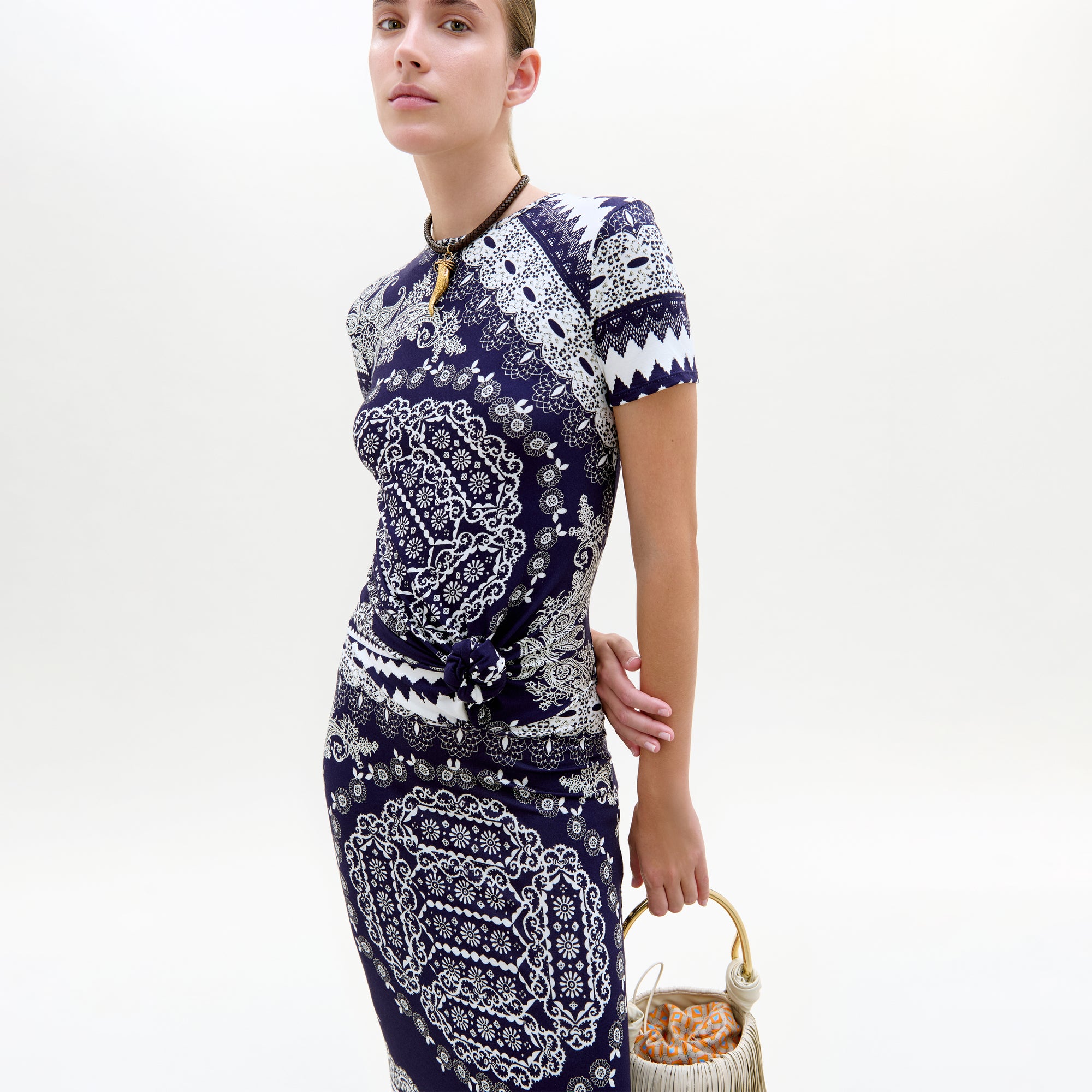 Woman wearing a blue and white patterned dress on a white background