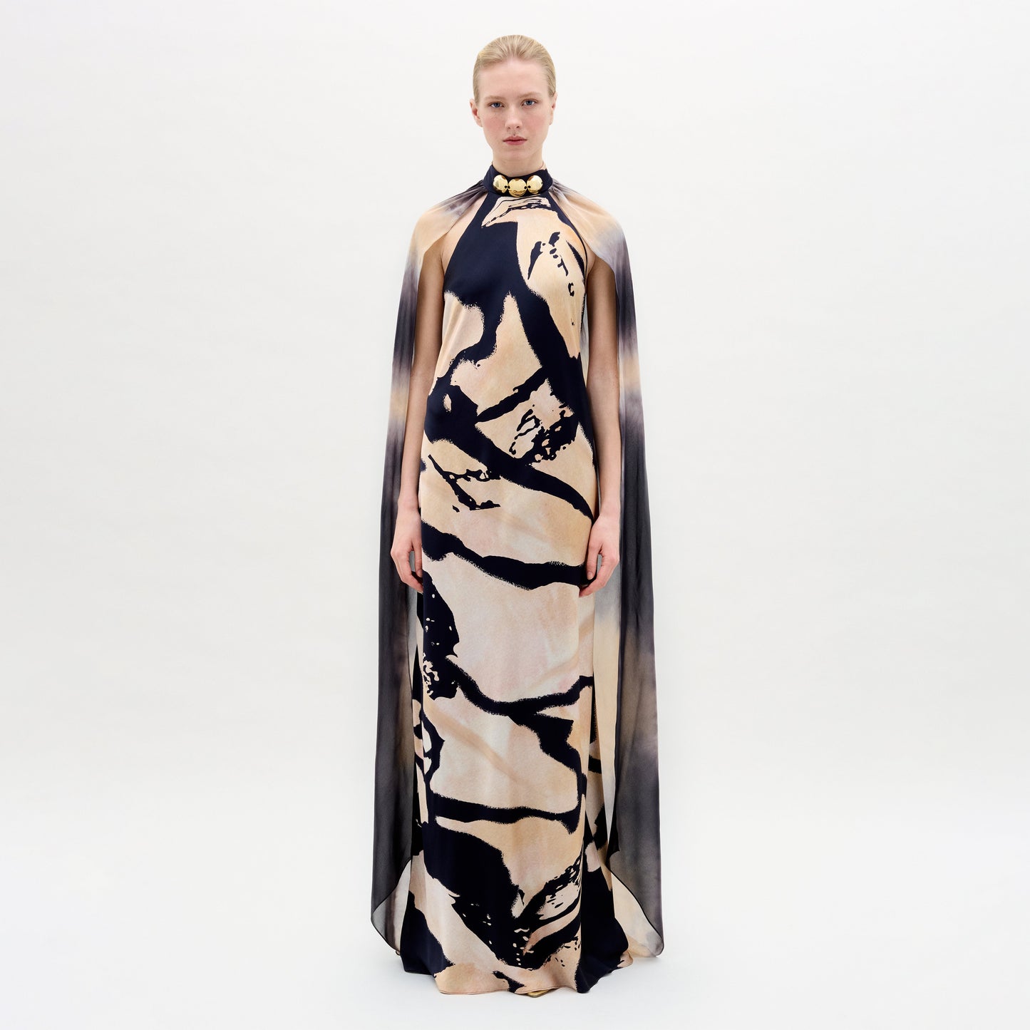 A woman wearing the Sabina Dress in color Black Beige Abstract on a white background.