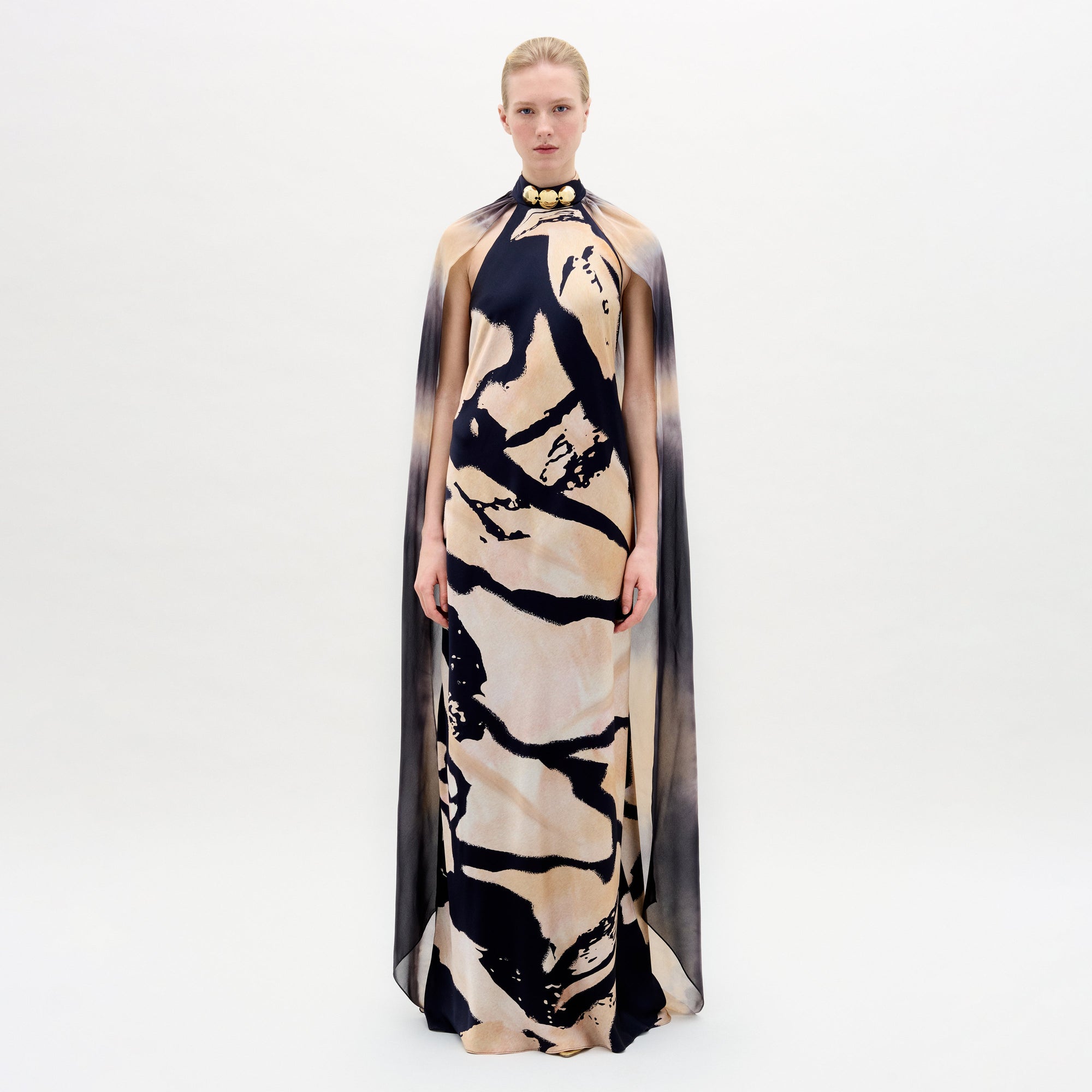 A woman wearing the Sabina Dress in color Black Beige Abstract on a white background.