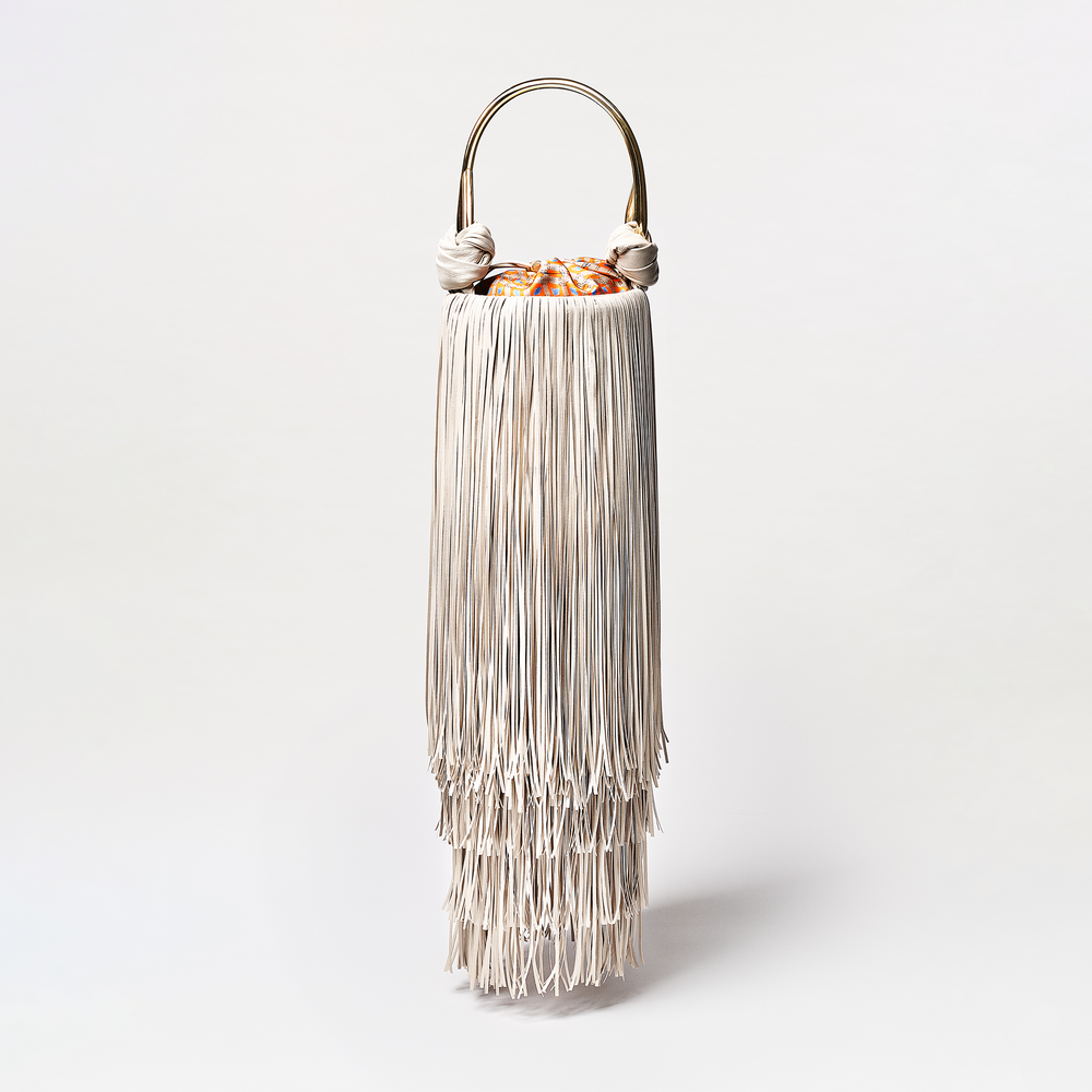 Decorative lamp with fringed design on a white background