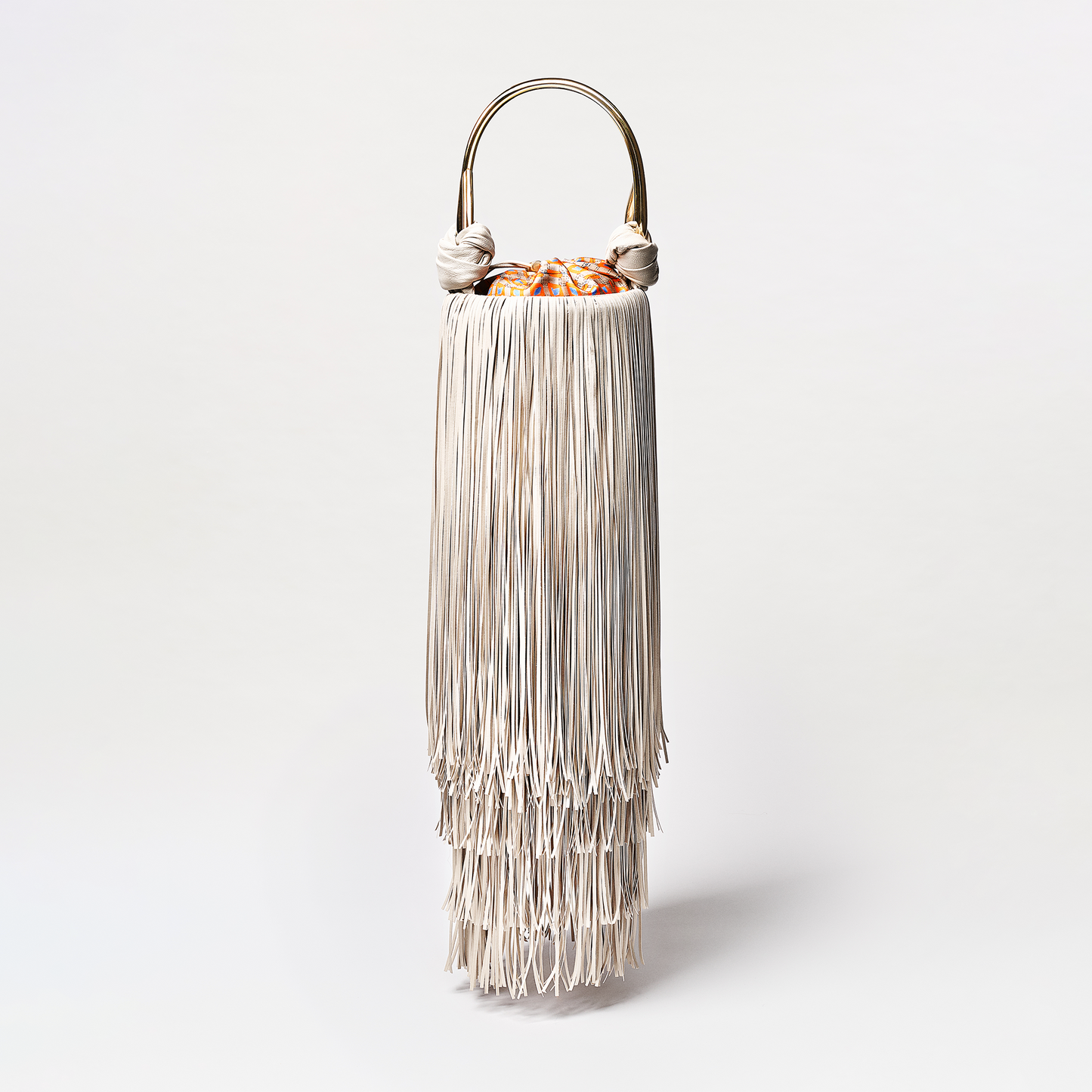 Decorative lamp with fringed design on a white background