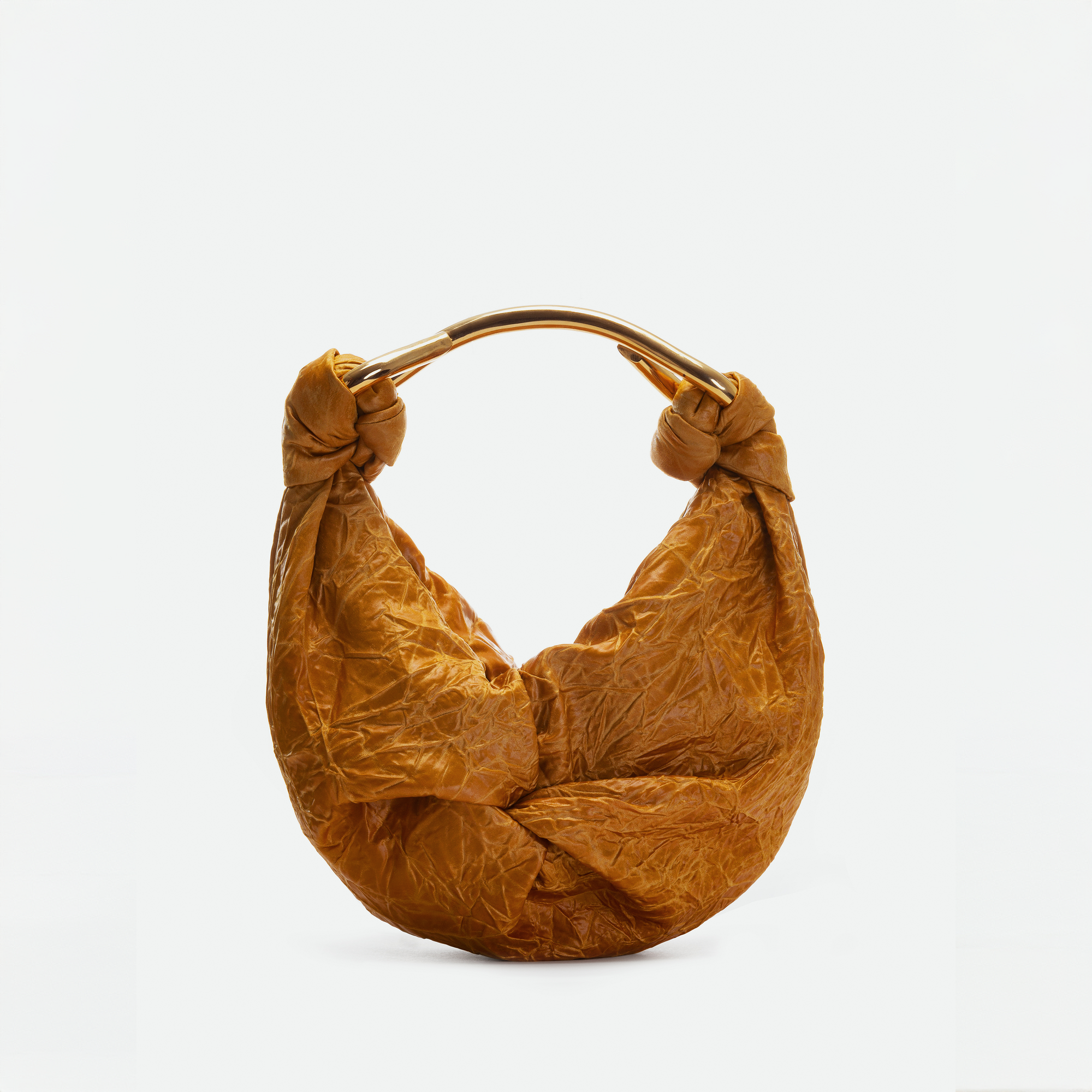 The Sofia Bag Small by SVT DESIGNS is a brown crescent-shaped handbag made from Italian fabric, with knotted corners and a curved gold-tone handle, shown on a plain white background.
