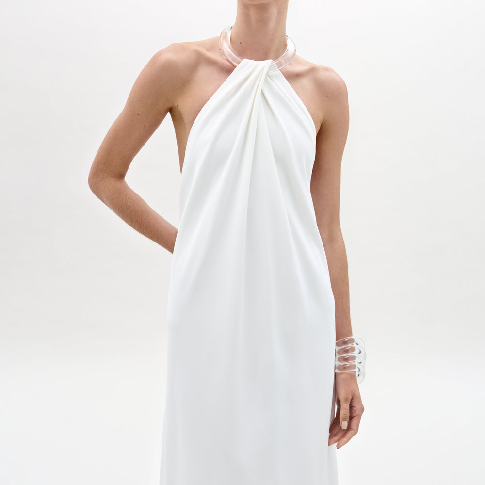 White halter neck dress on a plain background