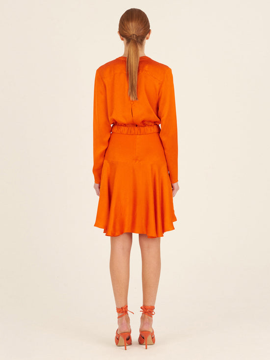 A Aglioni Dress Bright Orange mini-dress with a pink belt.