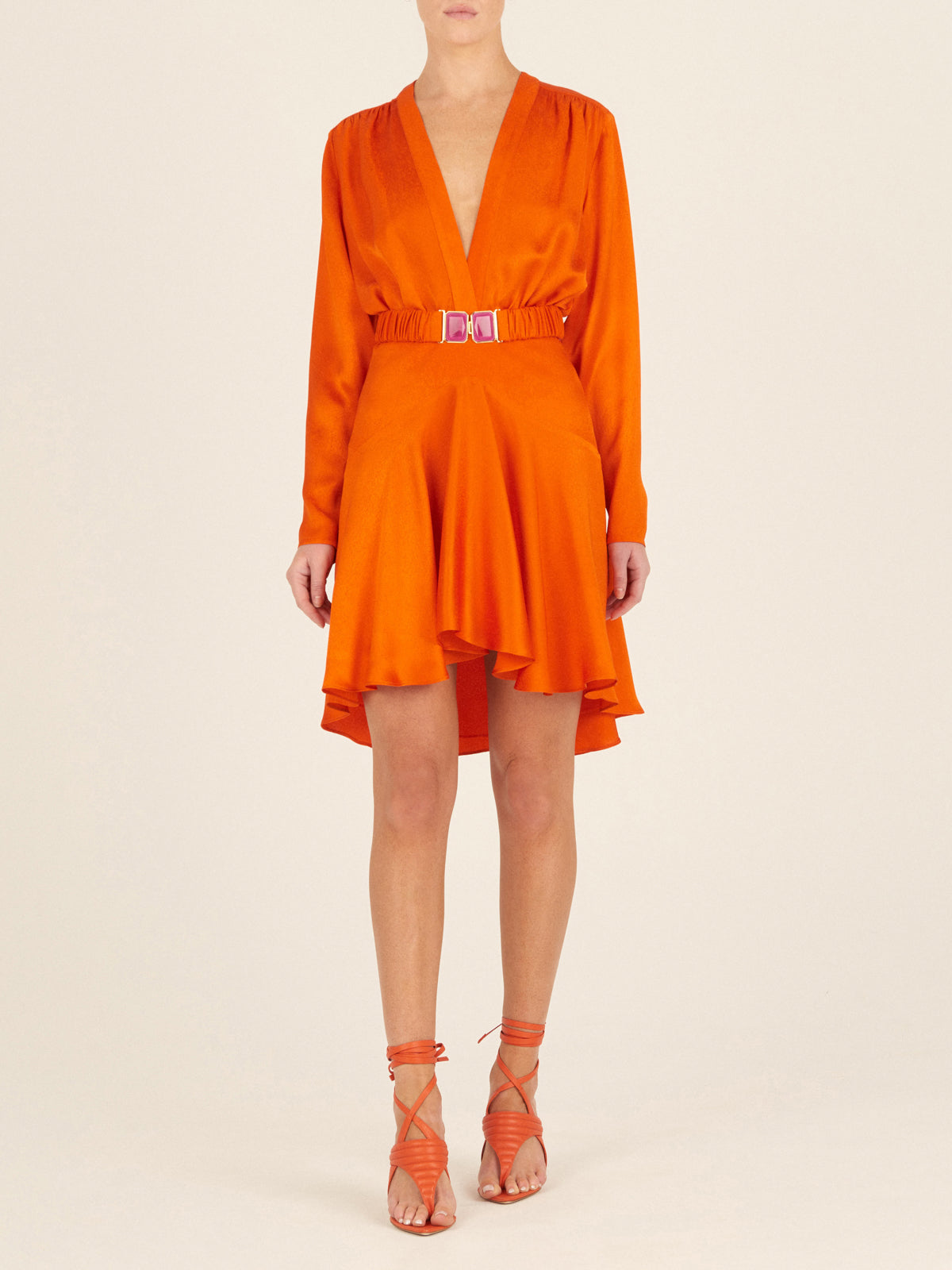 A Aglioni Dress Bright Orange mini-dress with a pink belt.