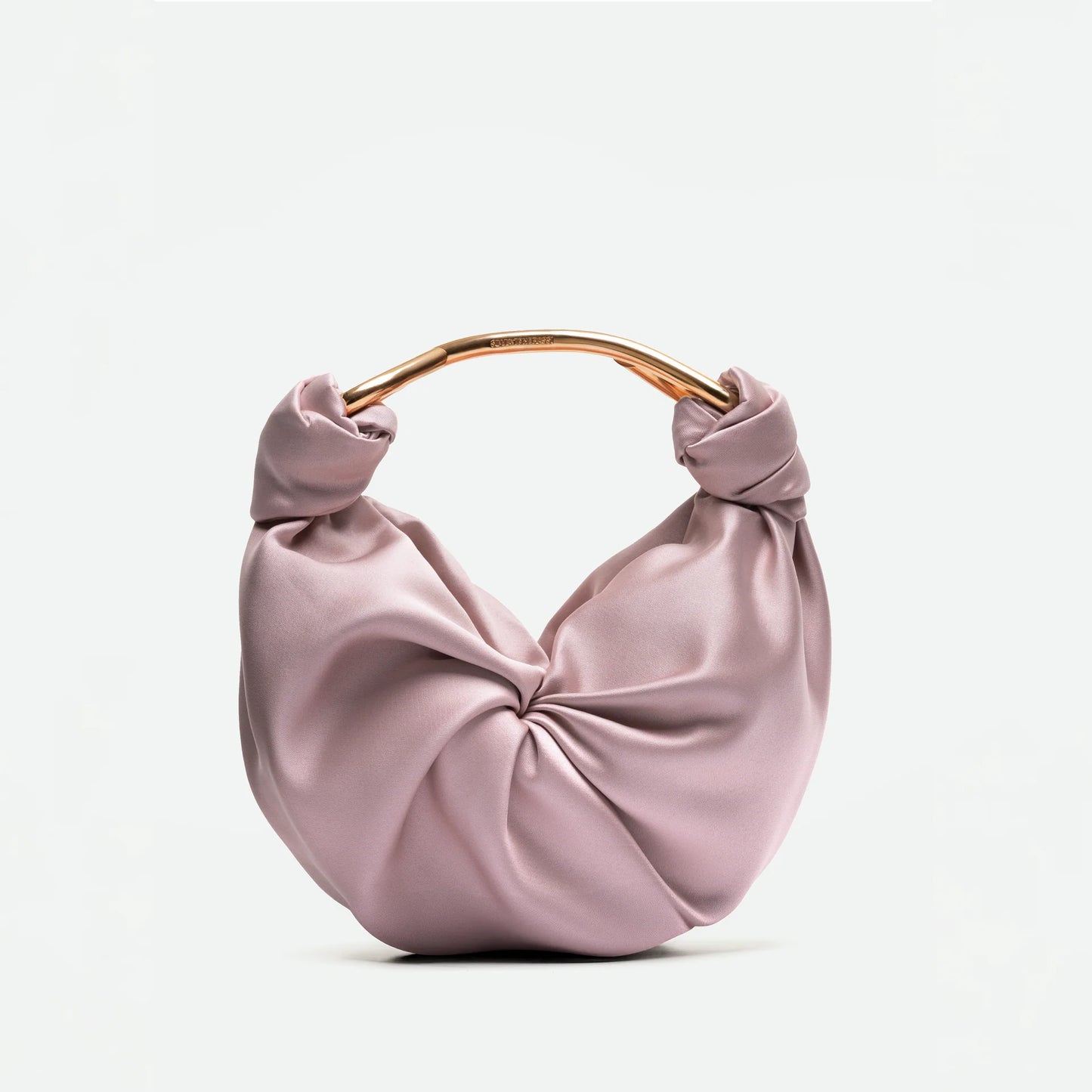 Pink handbag with a knotted design on a white background