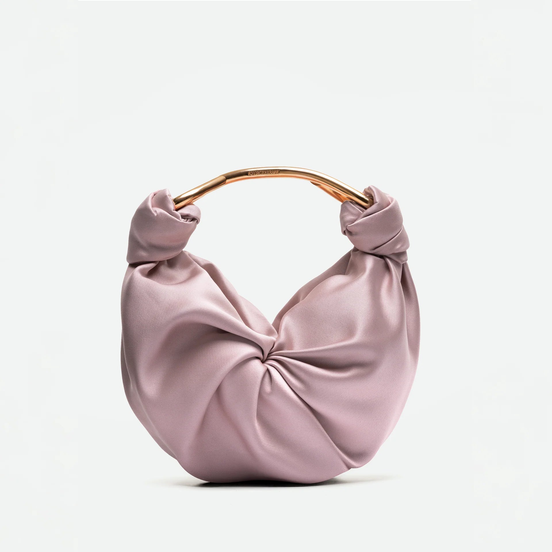 Pink handbag with a knotted design on a white background