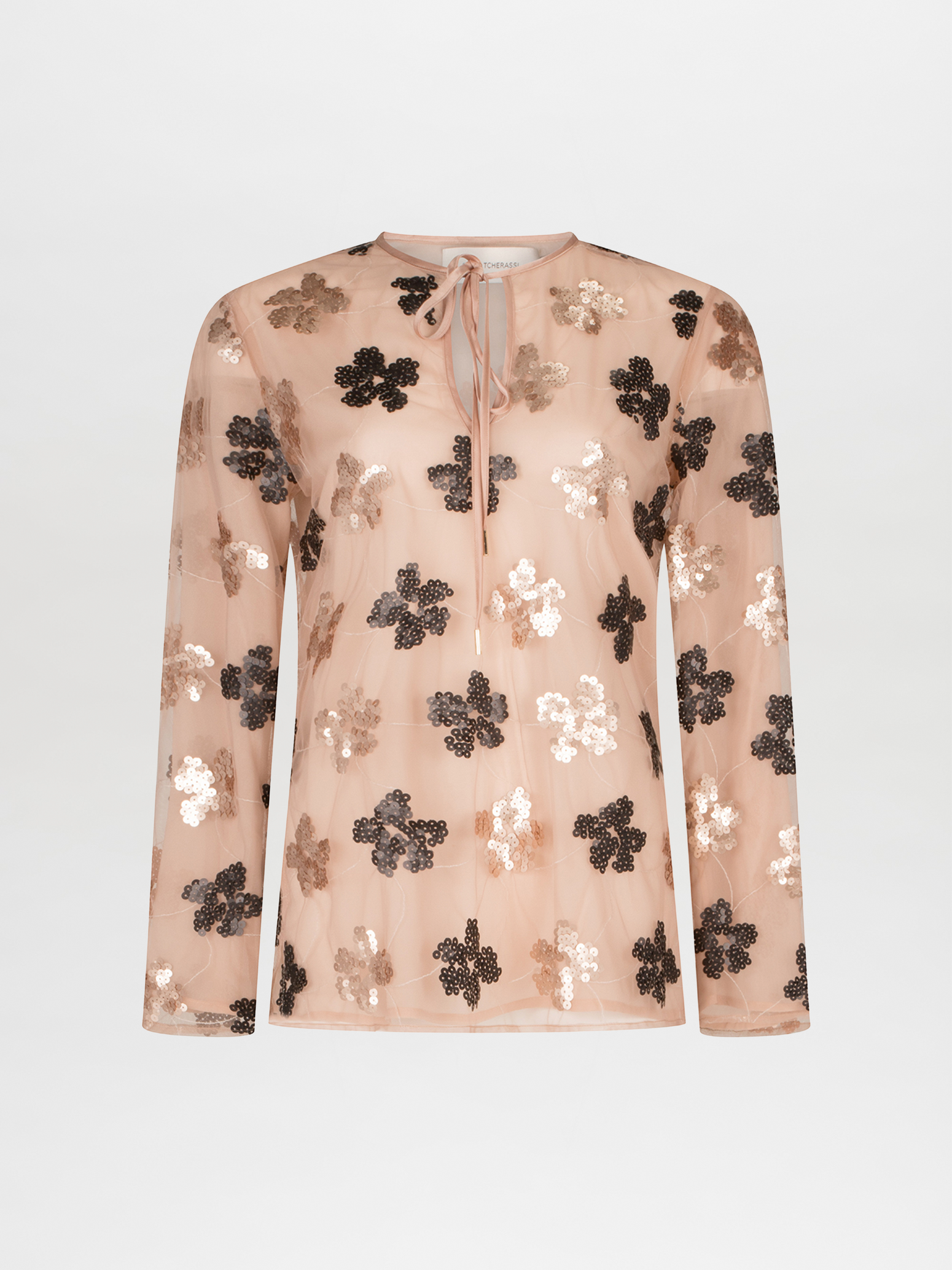 The Tosca Blouse by Silvia Tcherassi US is a sheer, beige long-sleeve top with floral sequins lace in black and metallic tones. It features a round keyhole neckline with a thin tie.