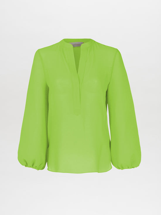 The Triora Blouse Verde Lime by Silvia Tcherassi boasts a chic silhouette with long sleeves and a V-shaped neckline on a plain white background. Slightly puffed cuffs add an elegant touch.