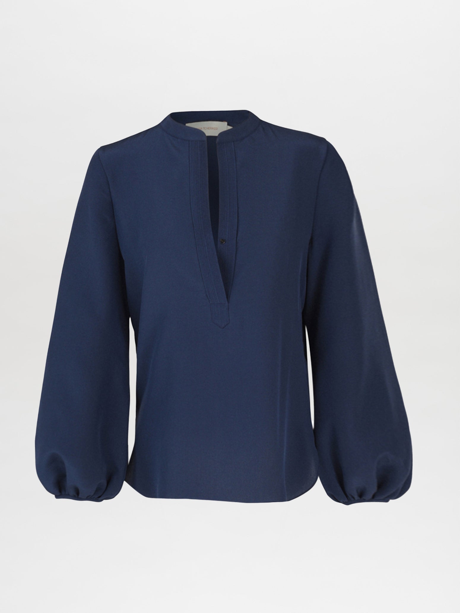 The Triora Blouse Navy Solid by Silvia Tcherassi features a navy color, V-neckline, and elegant billowing long sleeves, set against a white background. Minimalistic in design, it has no visible buttons or embellishments.