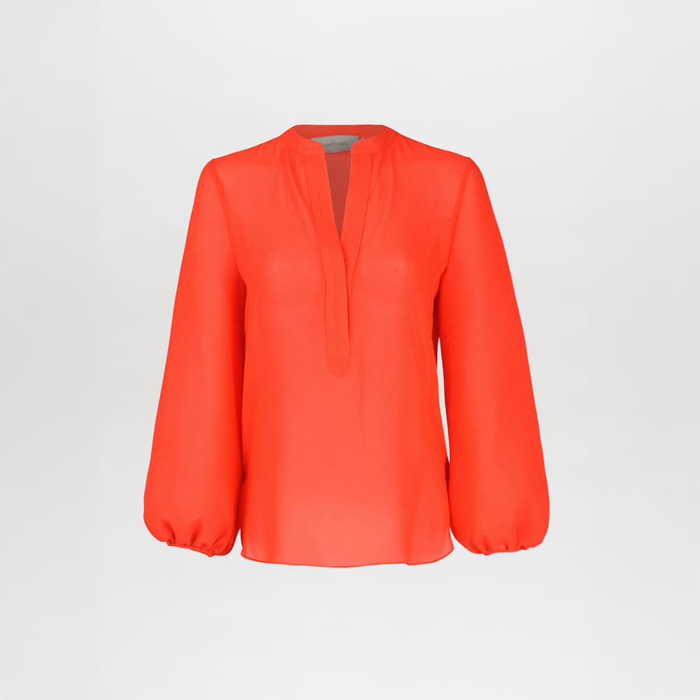 The Silvia Tcherassi Triora Blouse Tangerine—a long-sleeved, semi-sheer viscose V-neck with loose, billowy sleeves—is perfect for a chic outing. Shown on a plain white background.