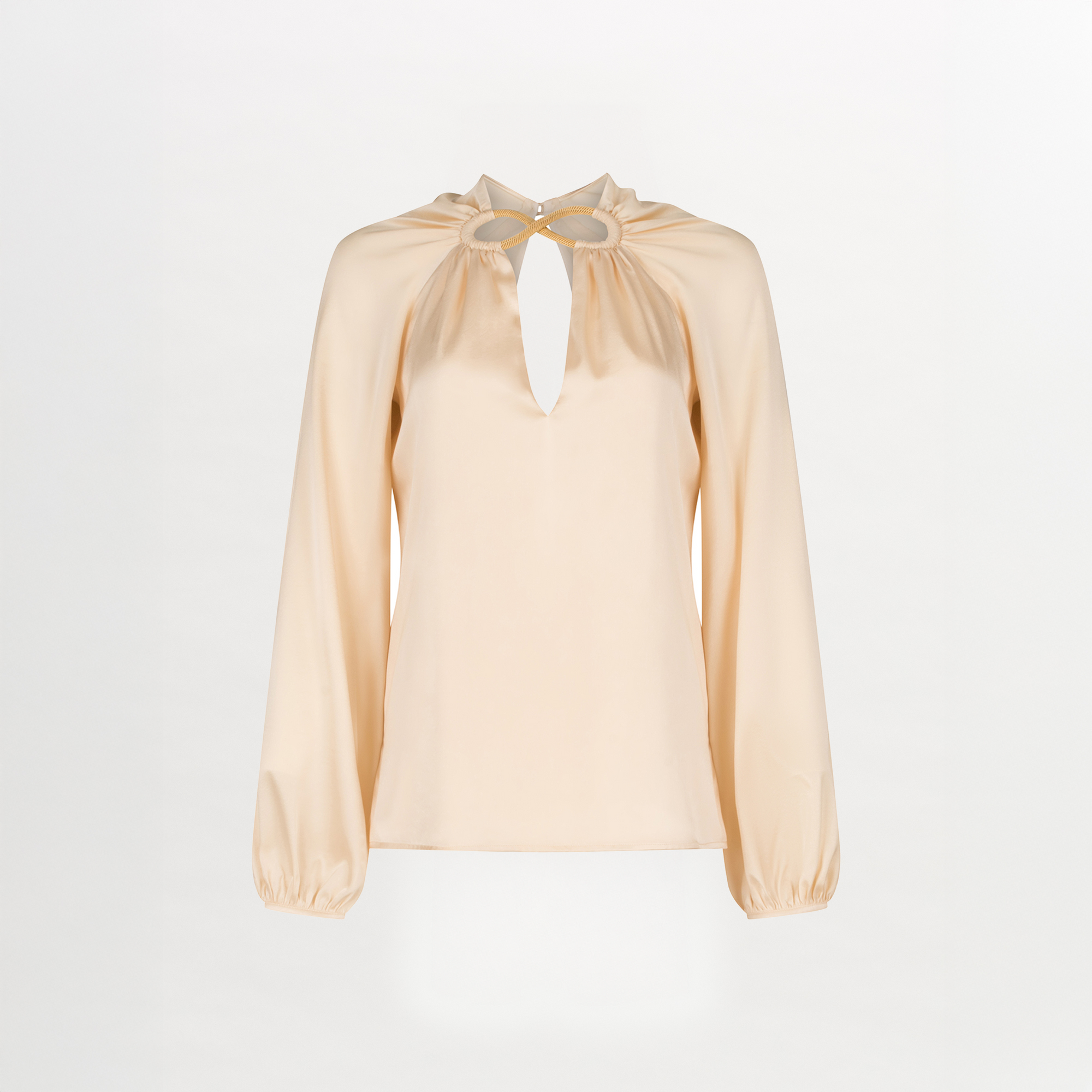 The Ximena Blouse by Silvia Tcherassi US features a silk-like, light beige satin finish, keyhole neckline with two gold accents, and loose gathered long sleeves for an elegant look.