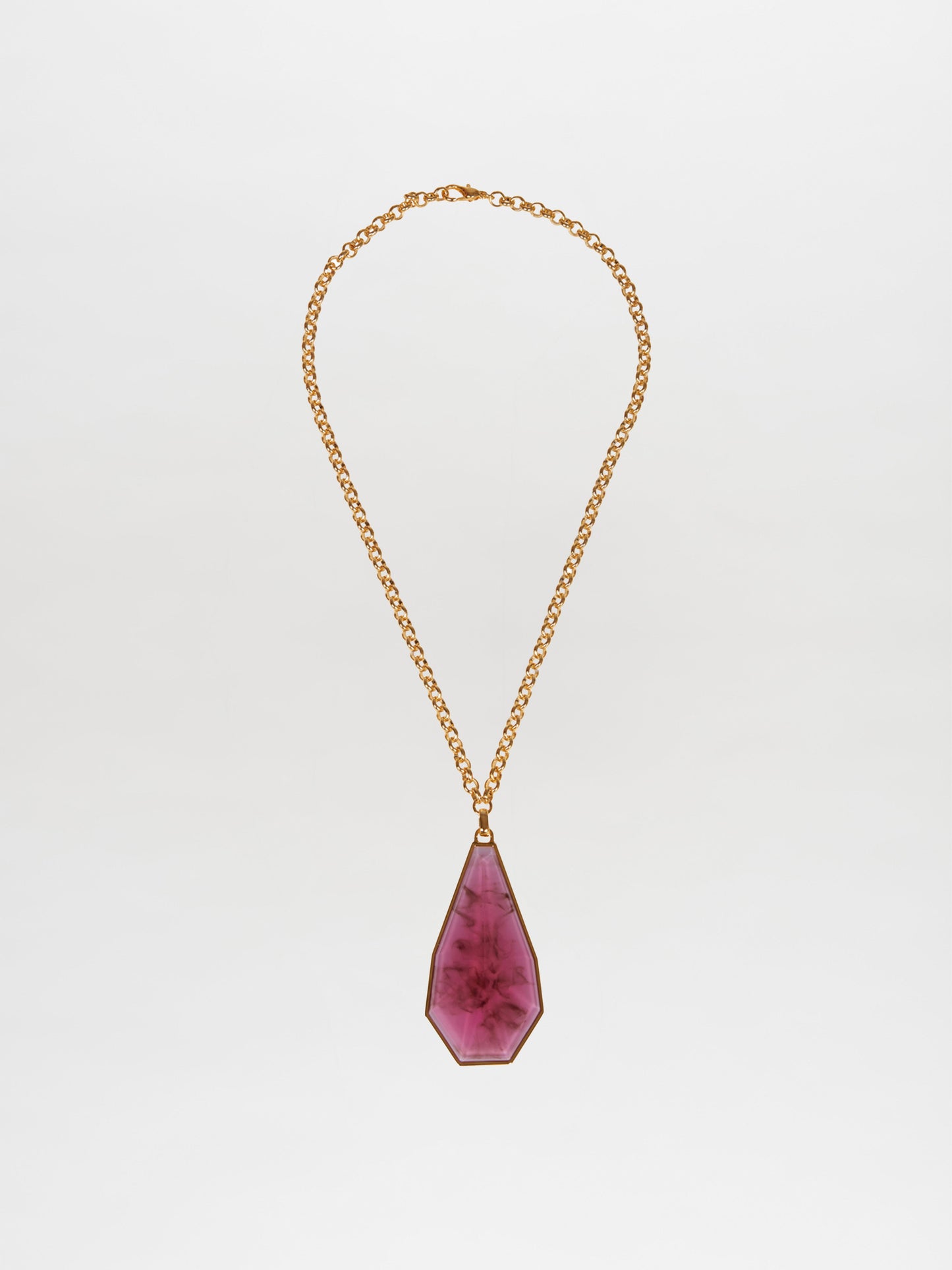 The Ascoli Necklace by Silvia Tcherassi features a large, faceted irregular pink gemstone pendant on a gold chain, elegantly displayed against a plain white background and is ready to order and ship promptly.