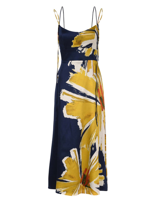 The Lizzo Dress Navy Floral Brushstrokes is a silk navy midi dress with spaghetti straps, showcasing a large yellow and white floral print alongside an A-line skirt.