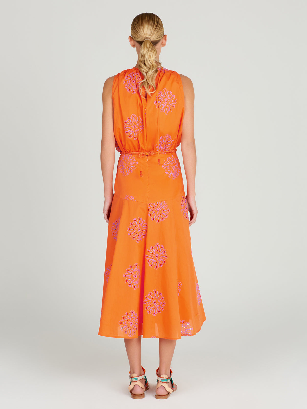 A Daila Dress Orange Lilac Embroidery with lilac-hued embroideries.