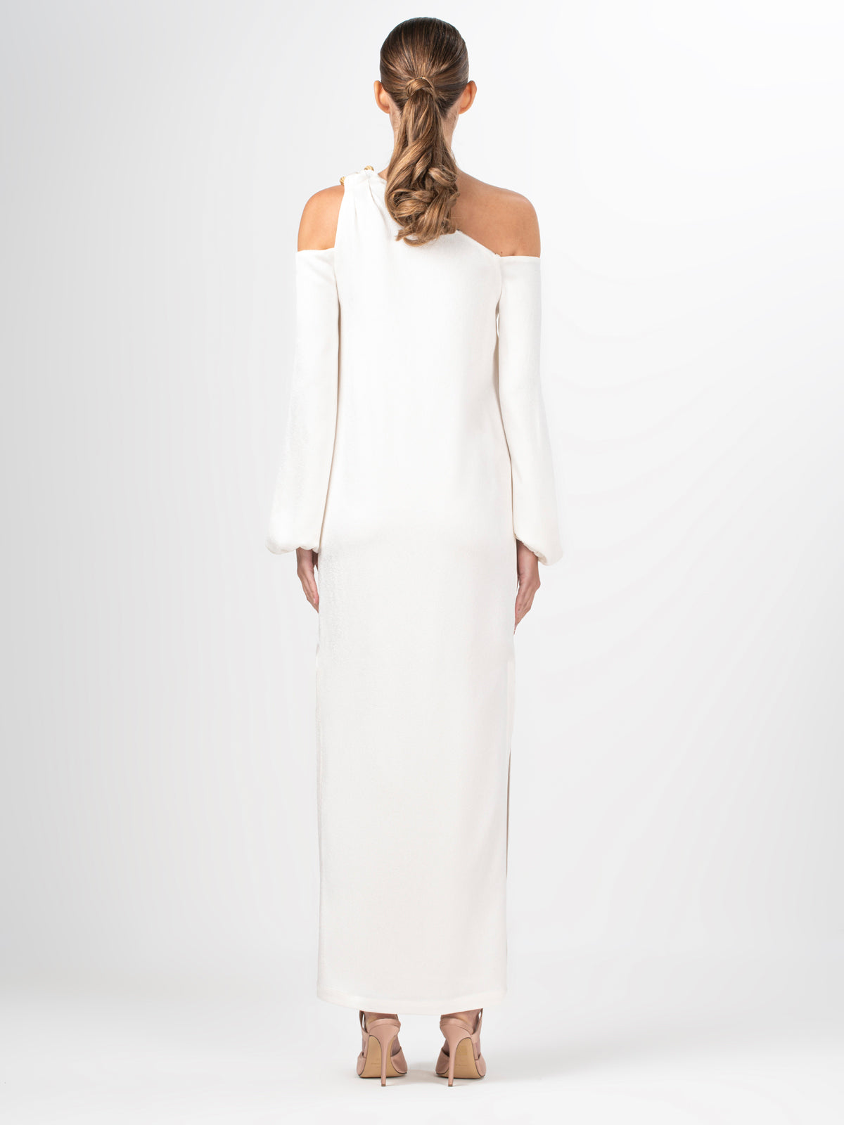 A Ada Dress White with a metallic gold shoulder detail.