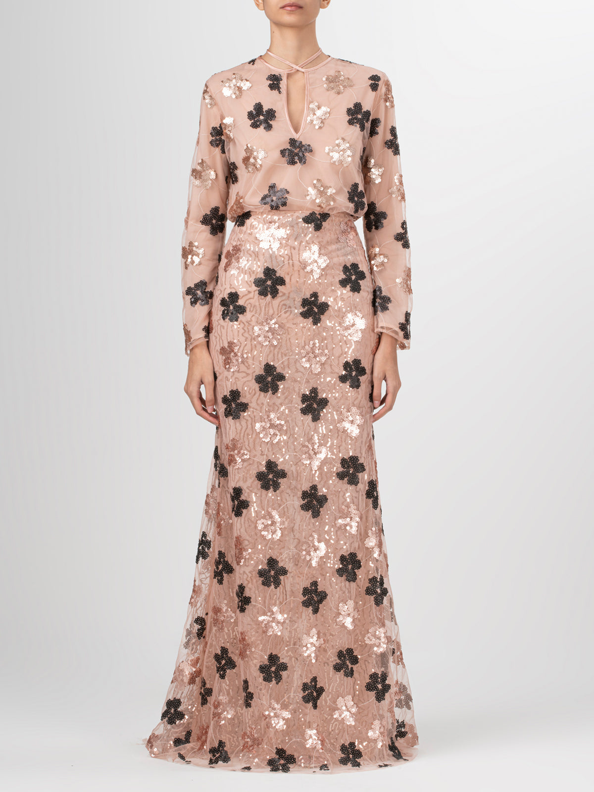 A Tosca Blouse Cacao Floral Sequin with black lace and gold sequins on it.