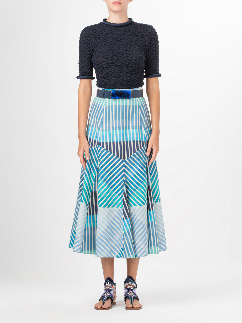 A Venecia Shirt Navy with a ruffled neckline pairs perfectly with metallic jewelry.